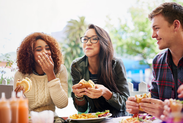 Cropped shot of three friends eating burgers outdoorshttp://195.154.178.81/DATA/i_collage/pi/shoots/784741.jpg