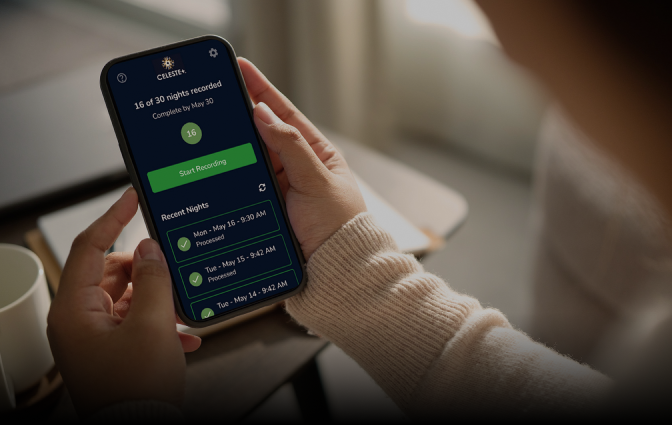 hands holding mobile phone with celeste screen showing