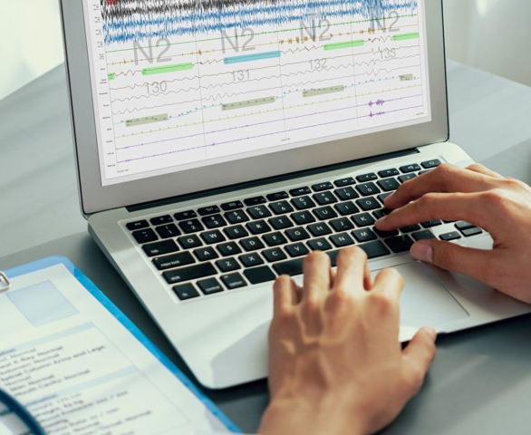 person on laptop with test results on screen