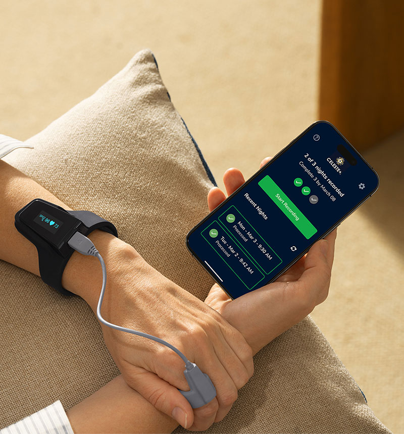 mockup of hand wearing the sleep test device and holding mobile phone with celeste app